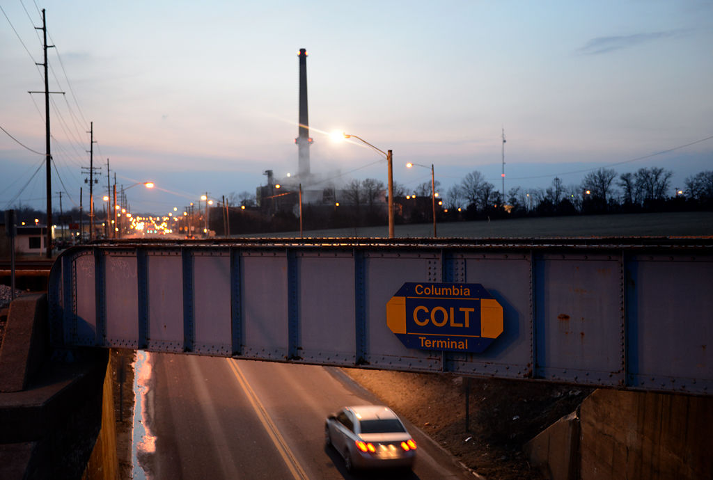 A view from an adjacent bridge shows a faded and rusting COLT railroad